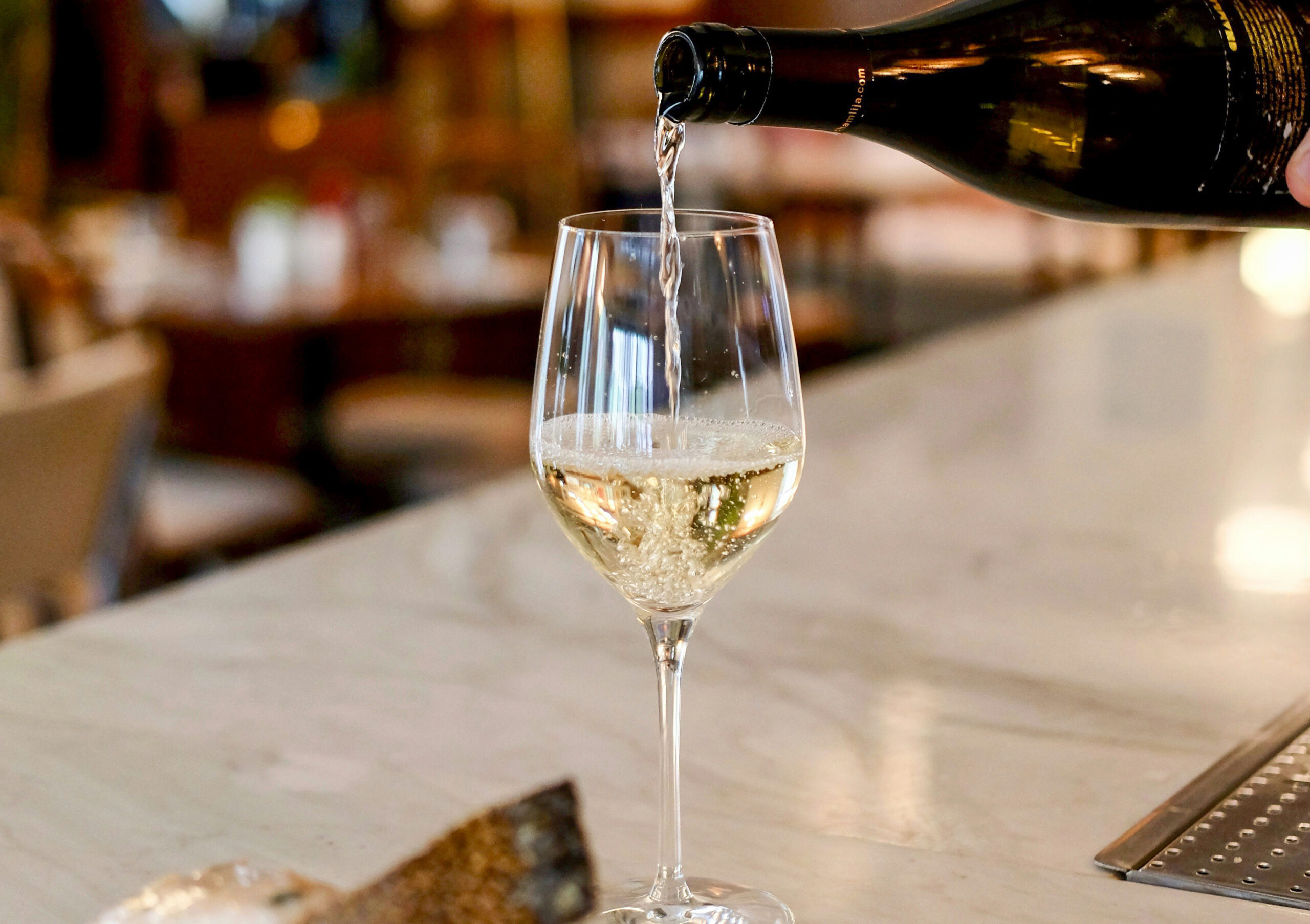 pinar-kucuk-w4C71BKJ6ko-unsplash-2 Photo of a table holding two wood boxes containing wine bottols and a mason jar candle between them take by Laura Adai