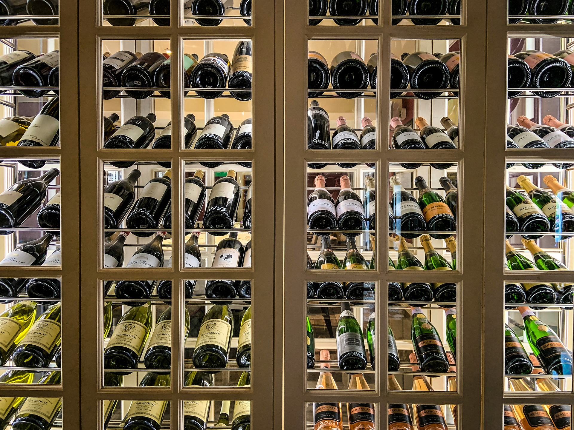 Photo of a large wine locker featuring many different types of wine